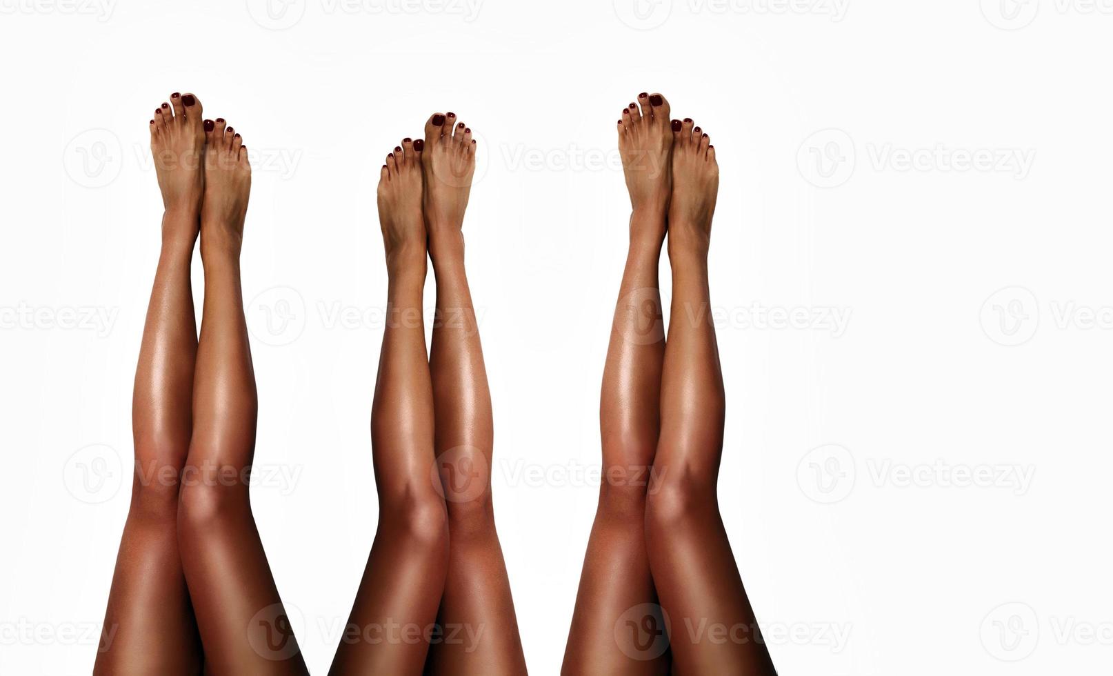 Beautiful smooth woman's legs after laser hair removal on the white background. Treatment, technology concept photo