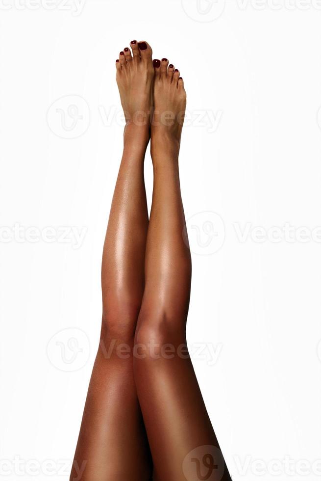 Beautiful smooth woman's legs after laser hair removal on the white background. Treatment, technology concept photo