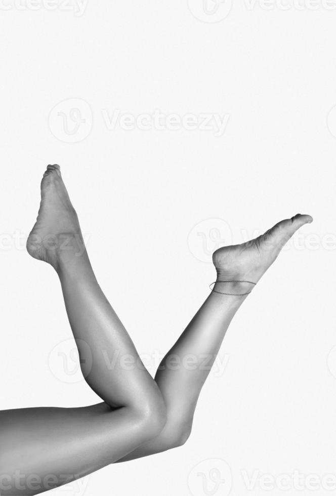 Beautiful smooth woman legs after laser hair removal on the colorful background. Treatment, technology concept photo