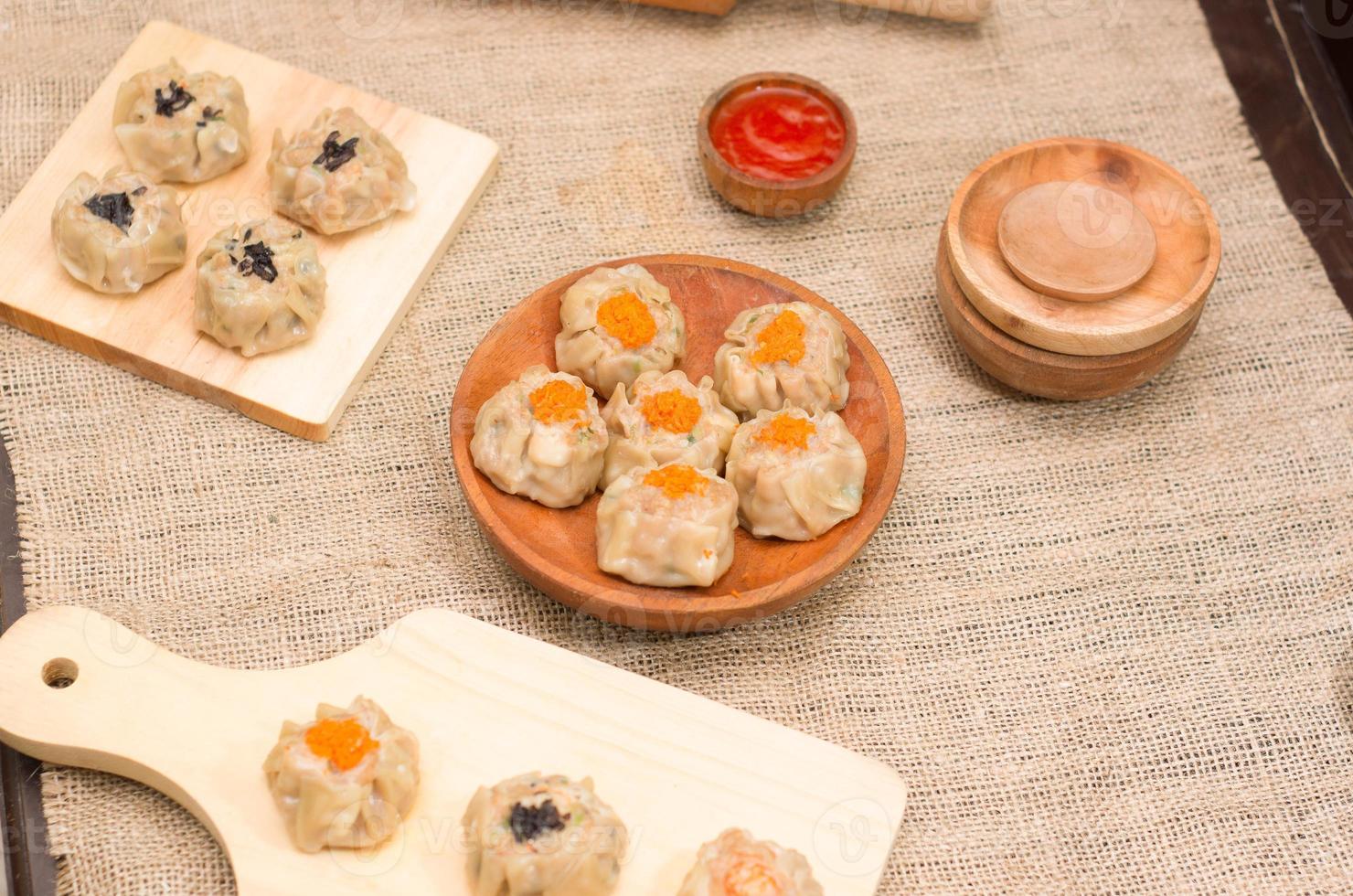Dim sum or dimsum flatlay photo with wooden plate