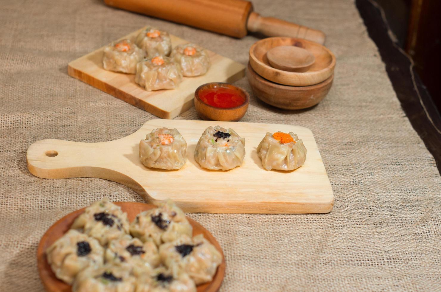 Chinese steamed dimsum or dim sum, on wooden plate, traditional cuisine photo