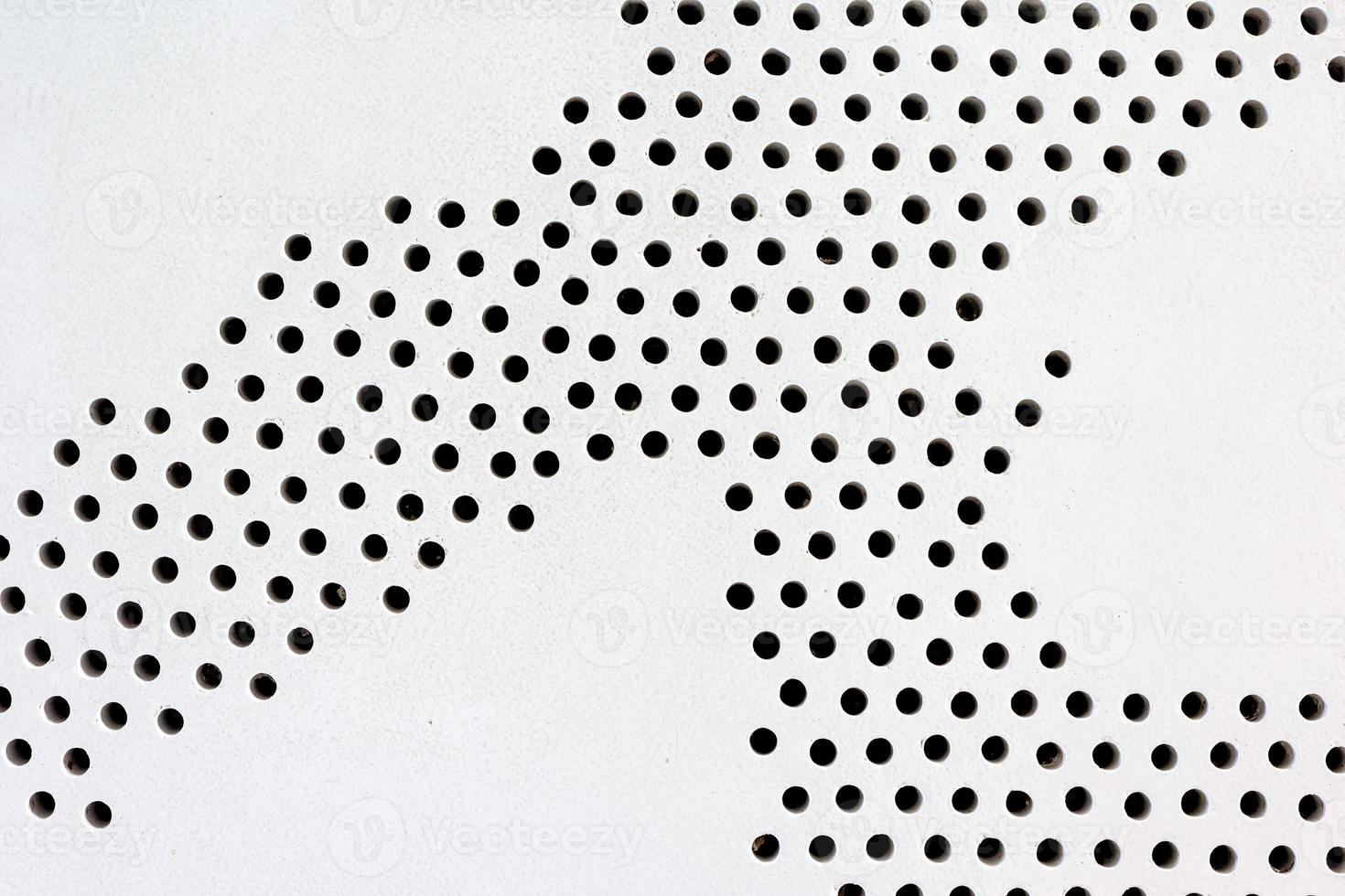 metal plate with holes on floor,abstract pattern photo