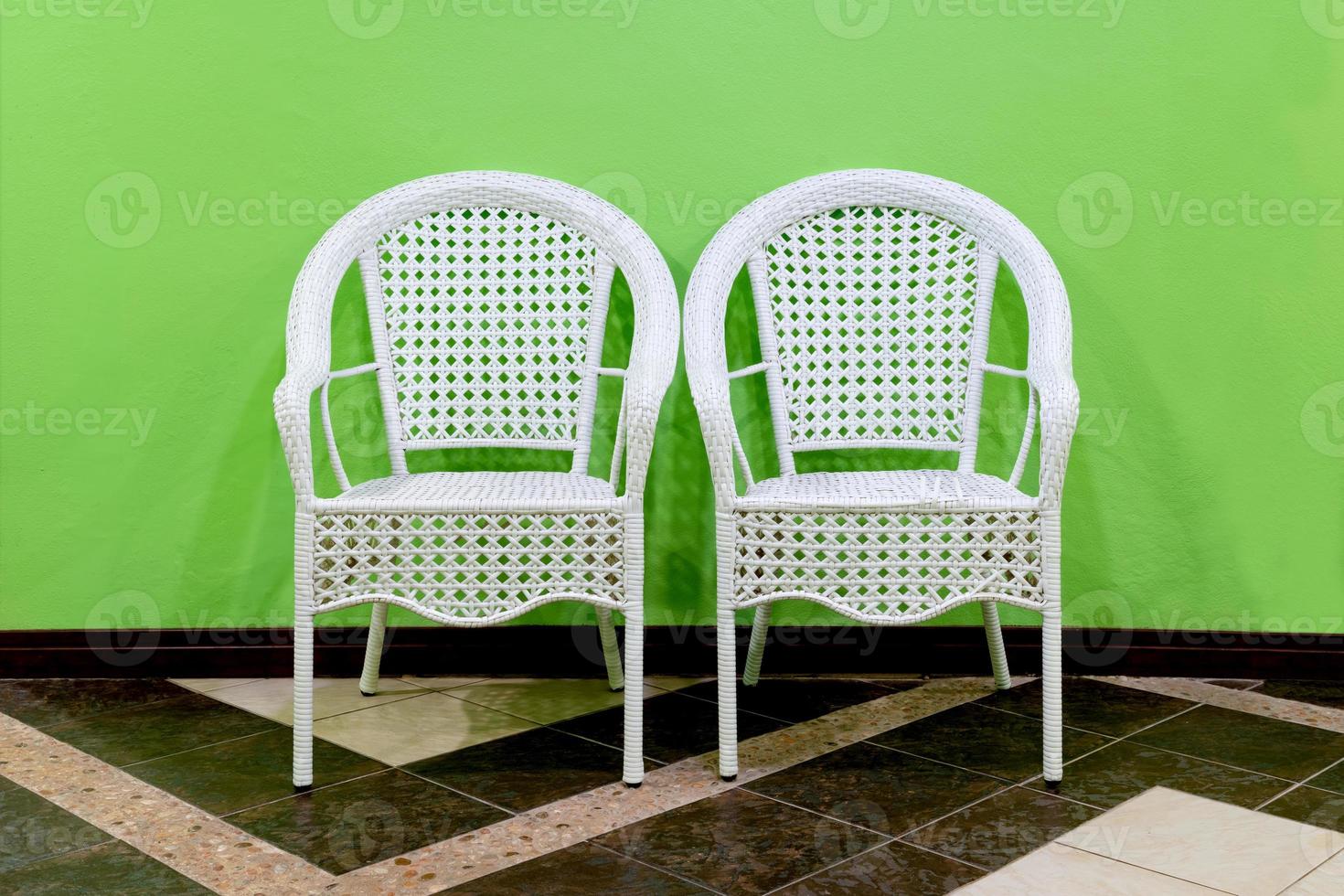 White Rattan Chair with green wall photo