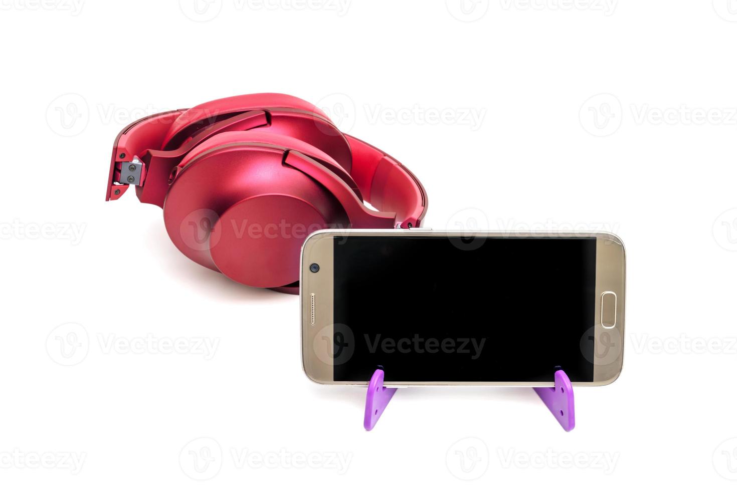 red headphones and mobile phone on tripod,isolated on white background photo