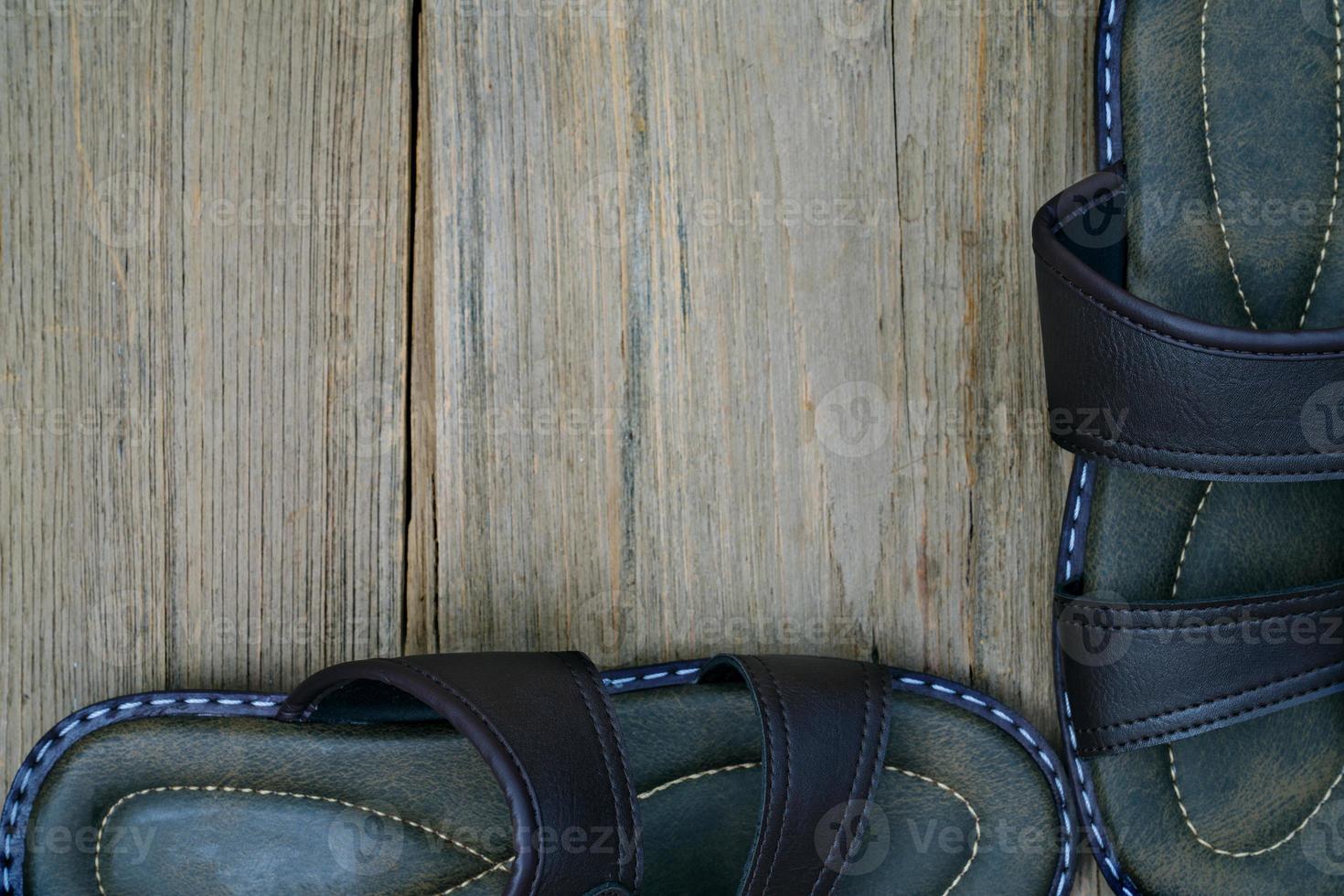 brown leather slippers on wood background,top view photo