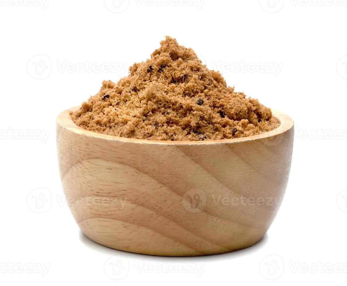 Brown cane sugar with wooden bowl isolated on white background photo