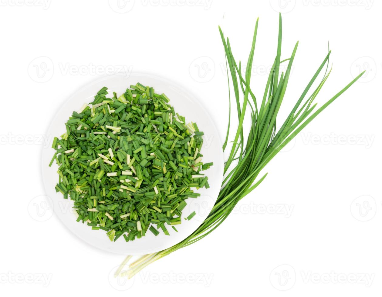Chop up the garlic chive on white dish,top view,isolated on white background photo