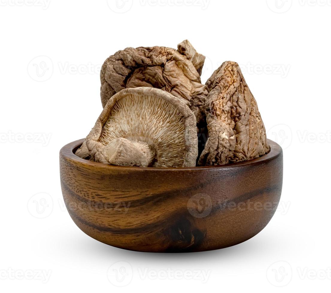 dry shiitake mushrooms in wooden bowl isolated on white background photo