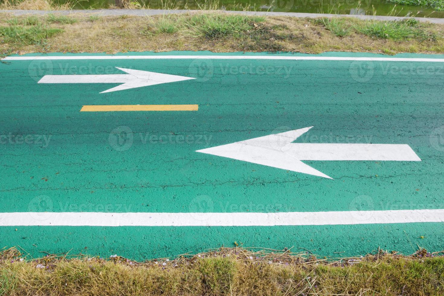 green road with white arrow. photo