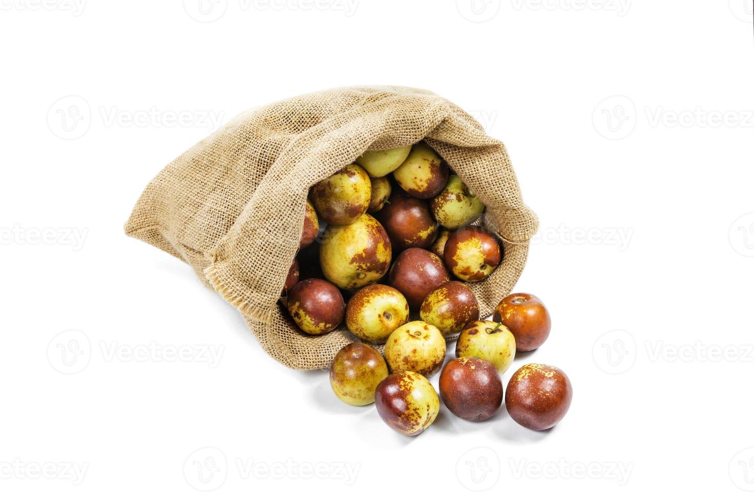 Chinese jujube in sack isolated on white background photo