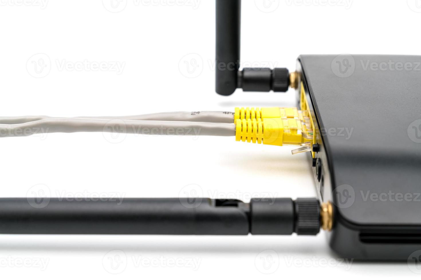 Black wireless router with local area network cable isolated on white background photo