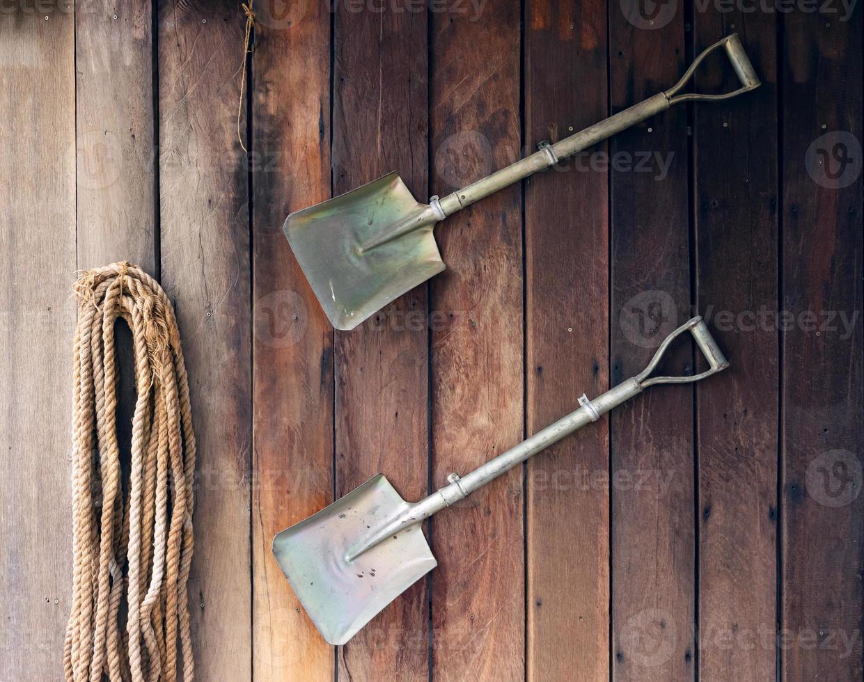 Shovel on old wooden wall background. photo