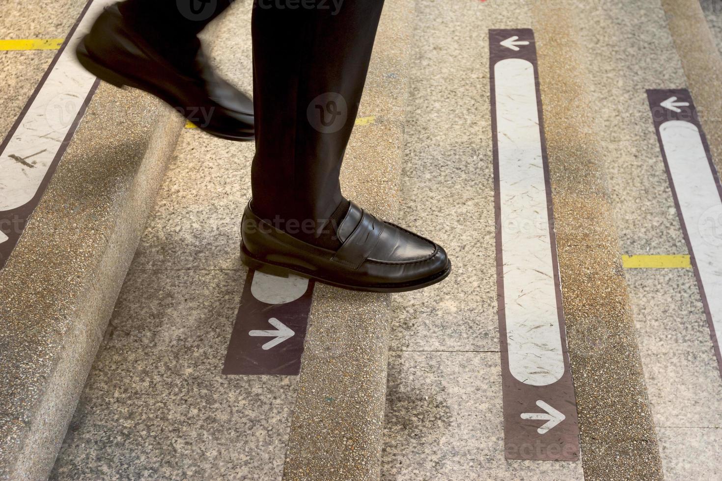 businessman legs walking down the stairs photo