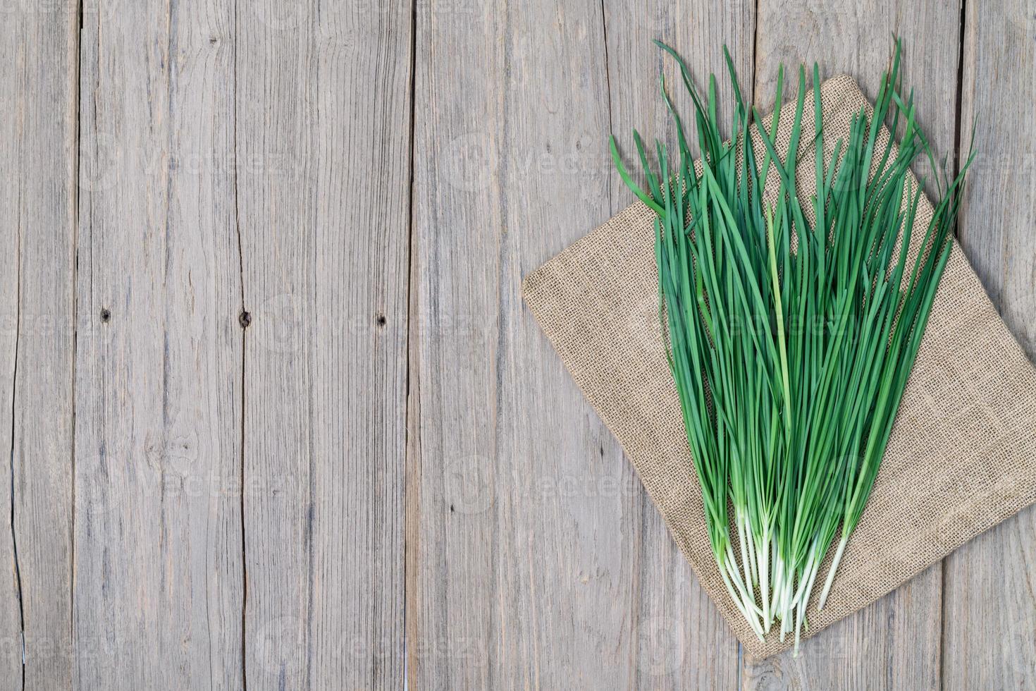 garlic chive on wood background,top view photo