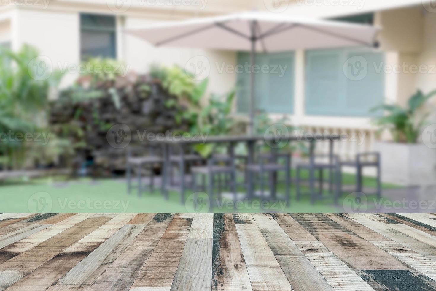 Top desk with blur outdoor restaurant background,wooden table photo