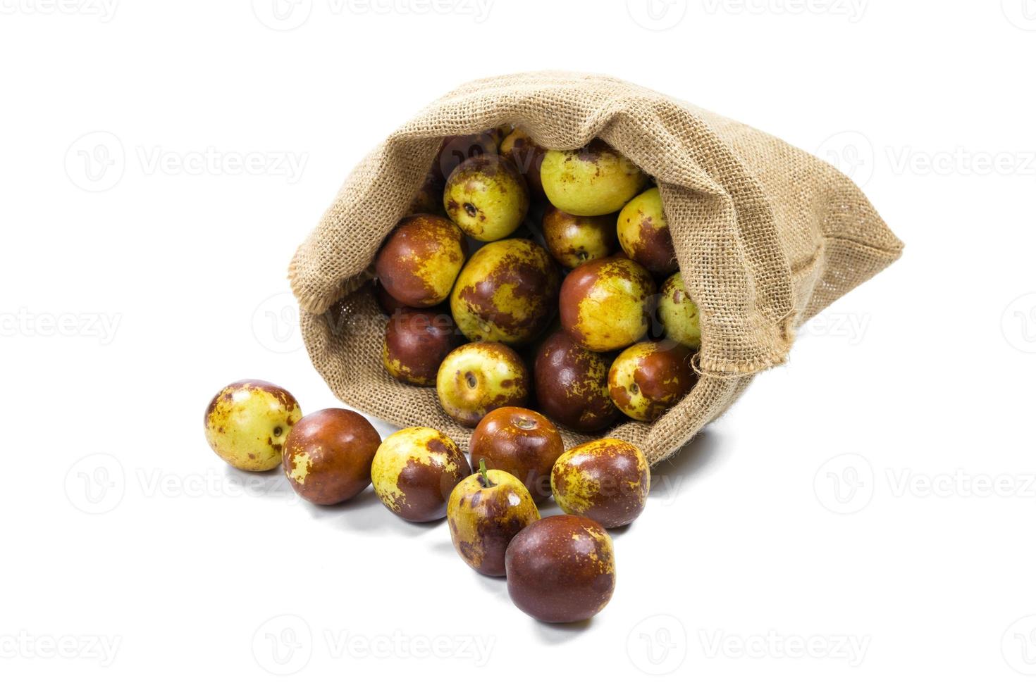 Chinese jujube in sack isolated on white background photo