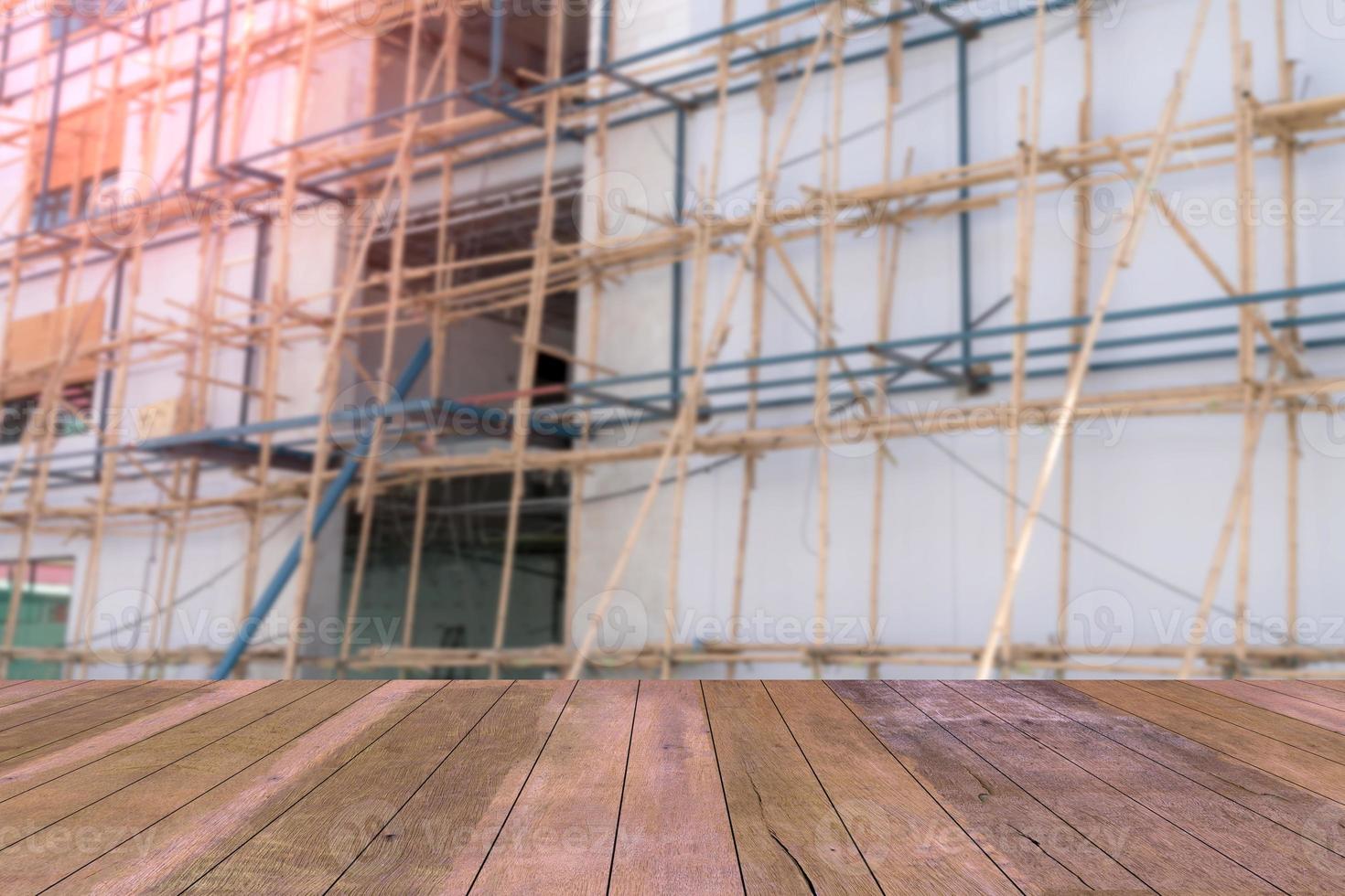 Top desk with blur scaffolding bamboo background,wooden table photo