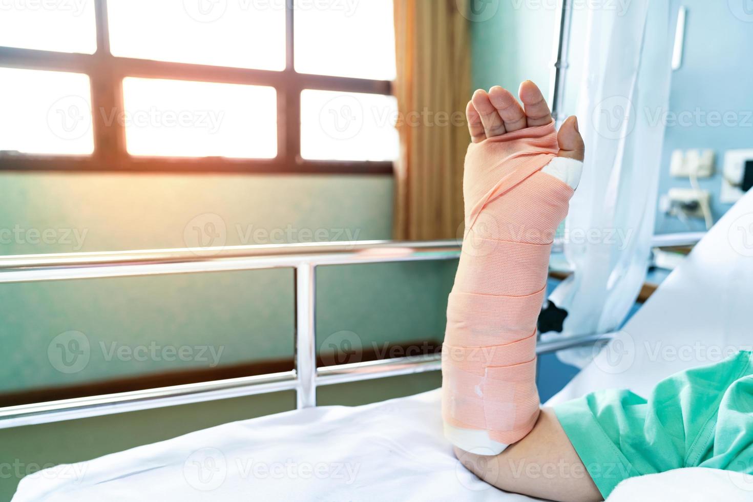 Broken arm patient on hospital bed photo