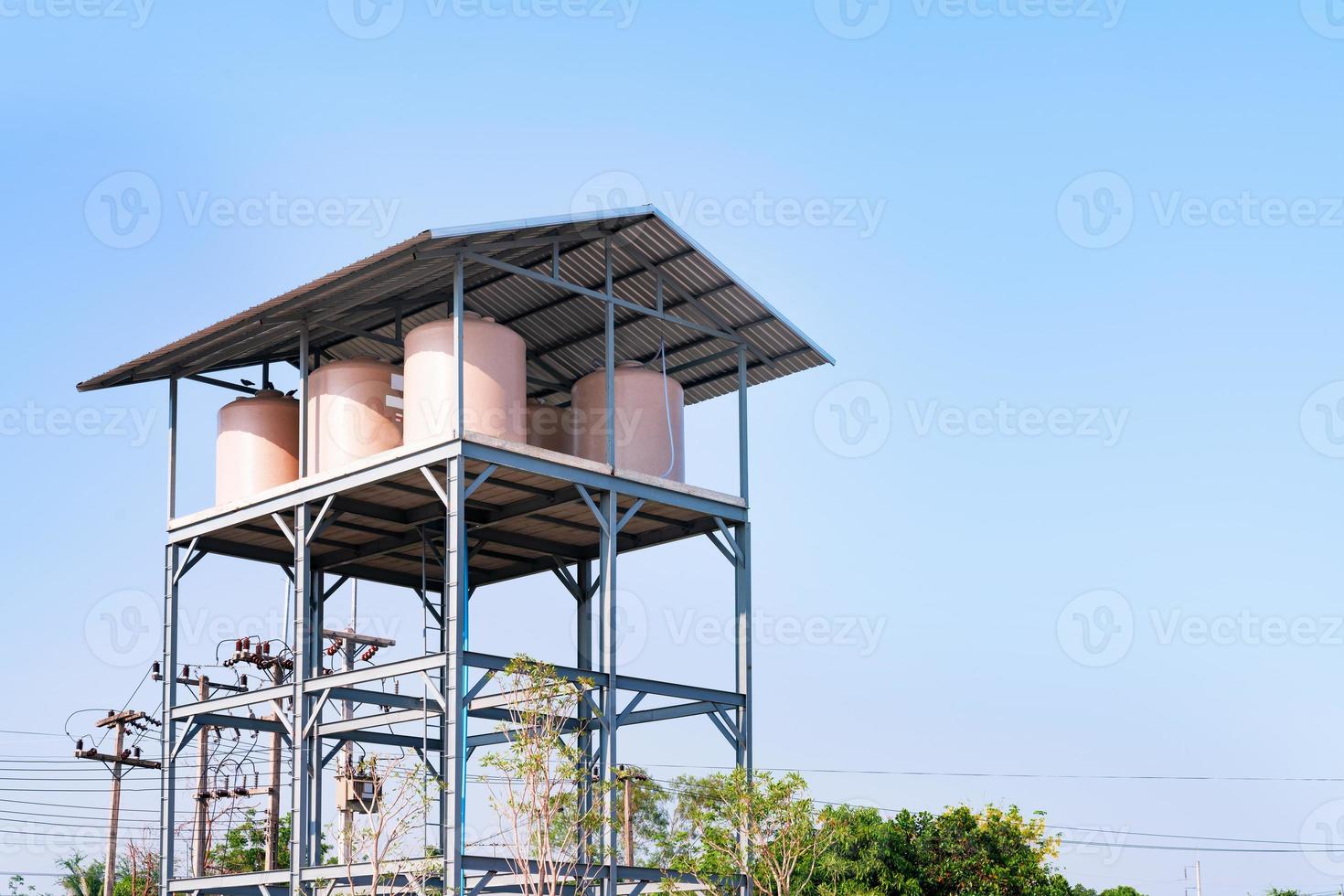 Brown plastic water tank on a tall stand photo