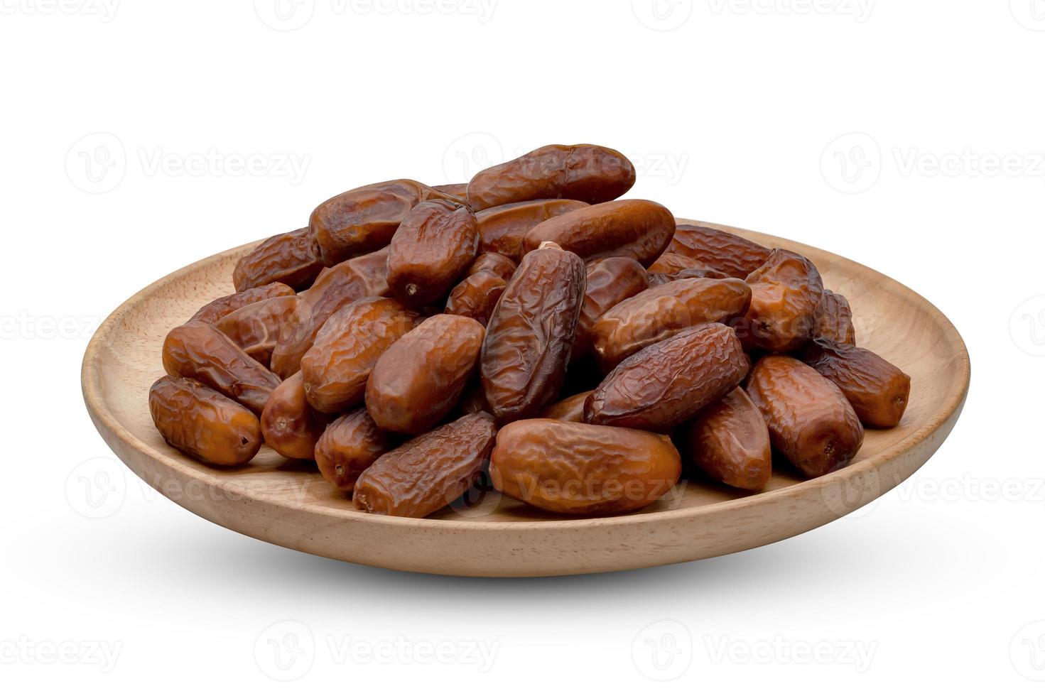 dry dates palm in wooden bowl isolated on white background ,include clipping path photo