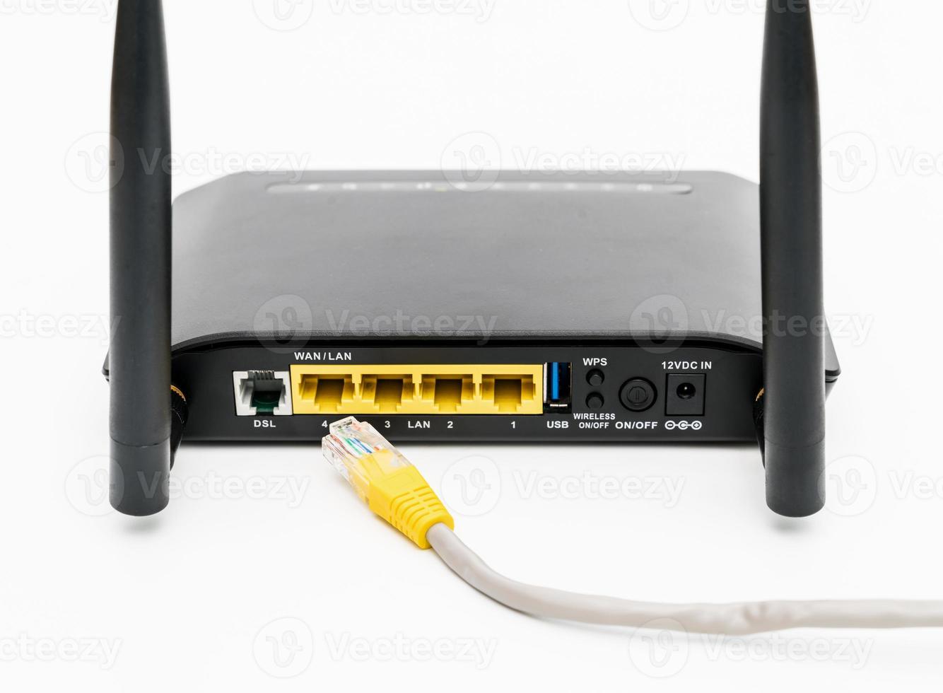 Black wireless router with local area network cable isolated on white background photo