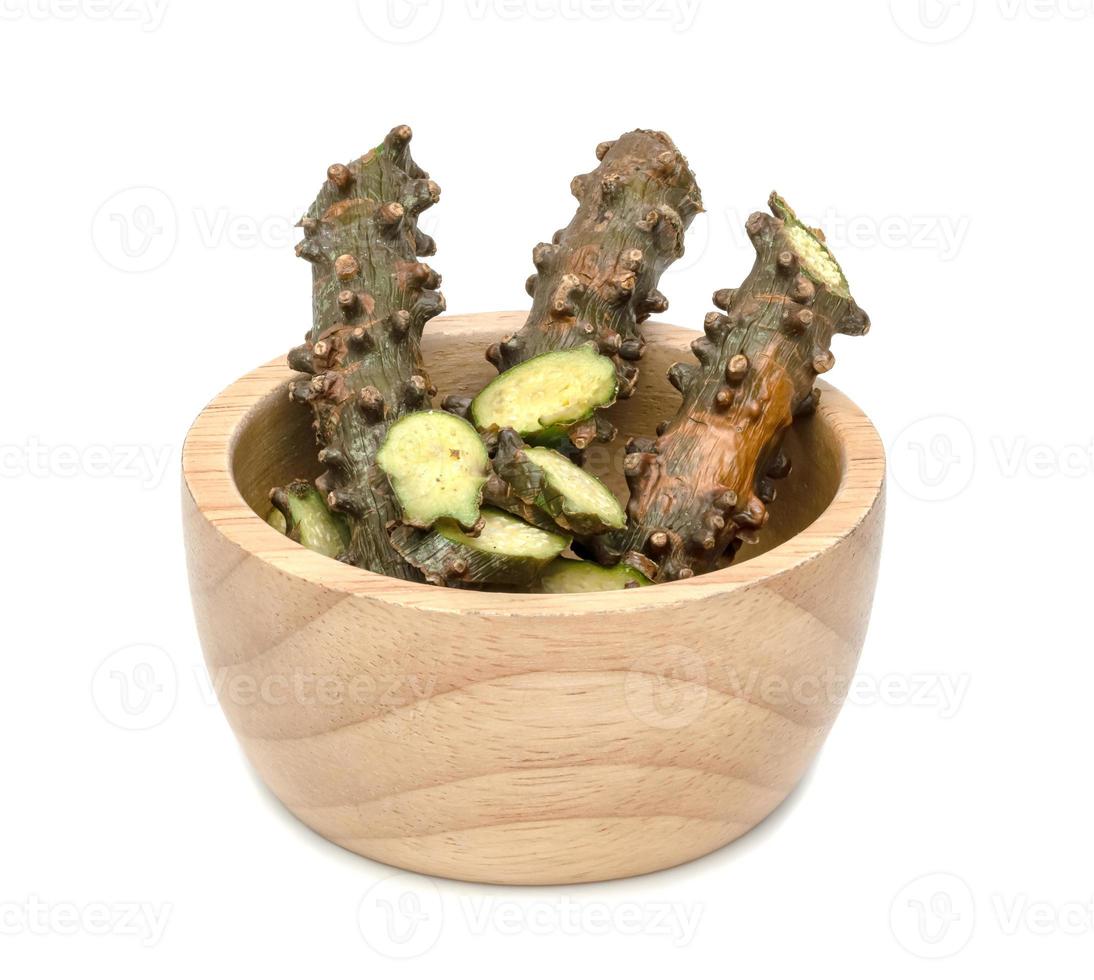Tinospora cordifolia or Tinospora crispa with wooden bowl isolated on white background photo