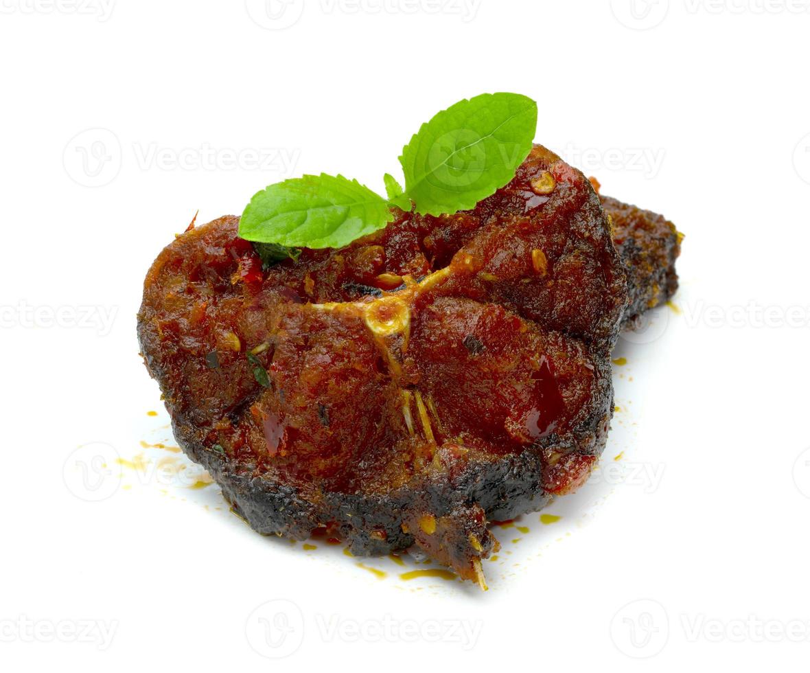 Stir Fried Crispy Catfish with Curry and leaf  fresh basil isolated on white background photo