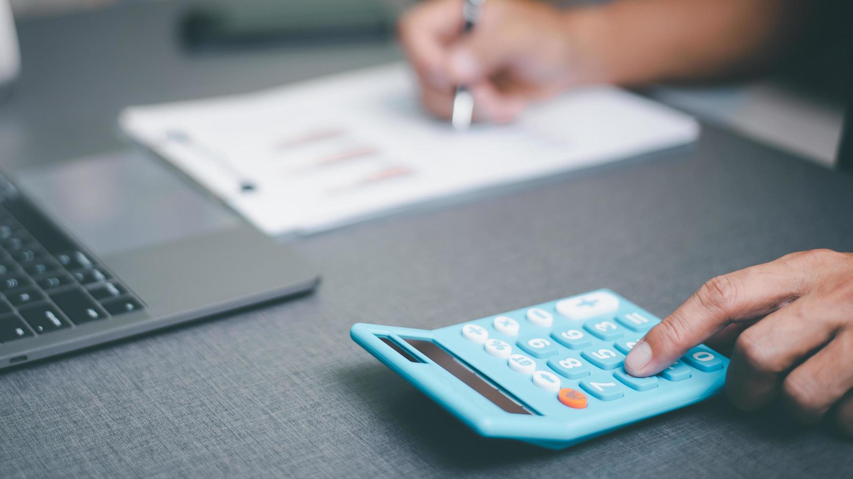 income tax management concepts and investment finance, management of accounting documents and budgets, annual statement review and analysis.paying the tax rate.businessman working on his desk photo