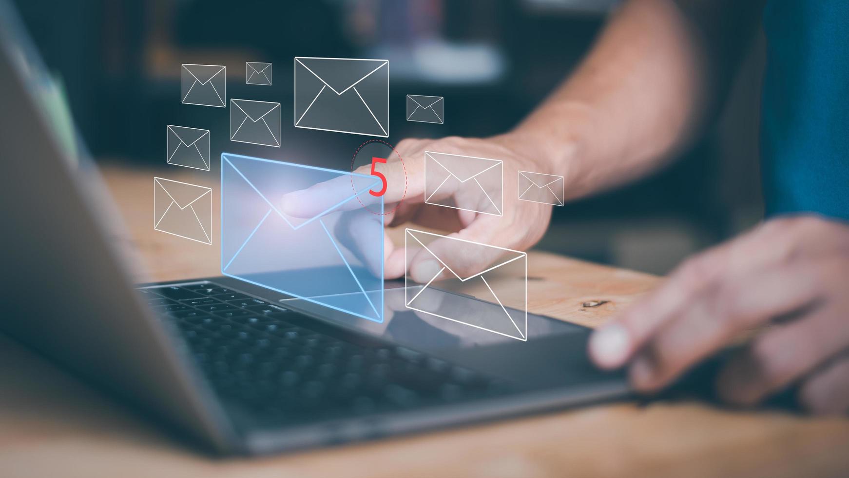 Businessman using laptop to open e-mail via virtual screen, Internet messaging concept, social media marketing, communicating with modern technology, online mail. photo
