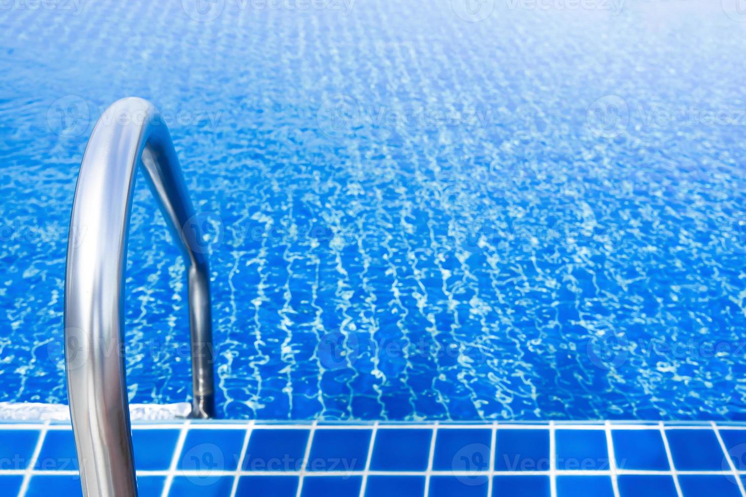 Grab bars stainless in the blue swimming pool photo