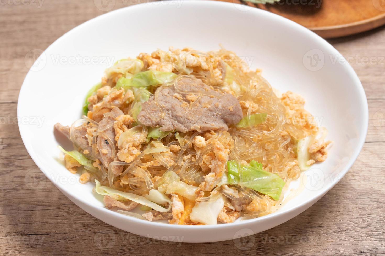 Stir fried vermicelli with pork, egg and collard greens in a white