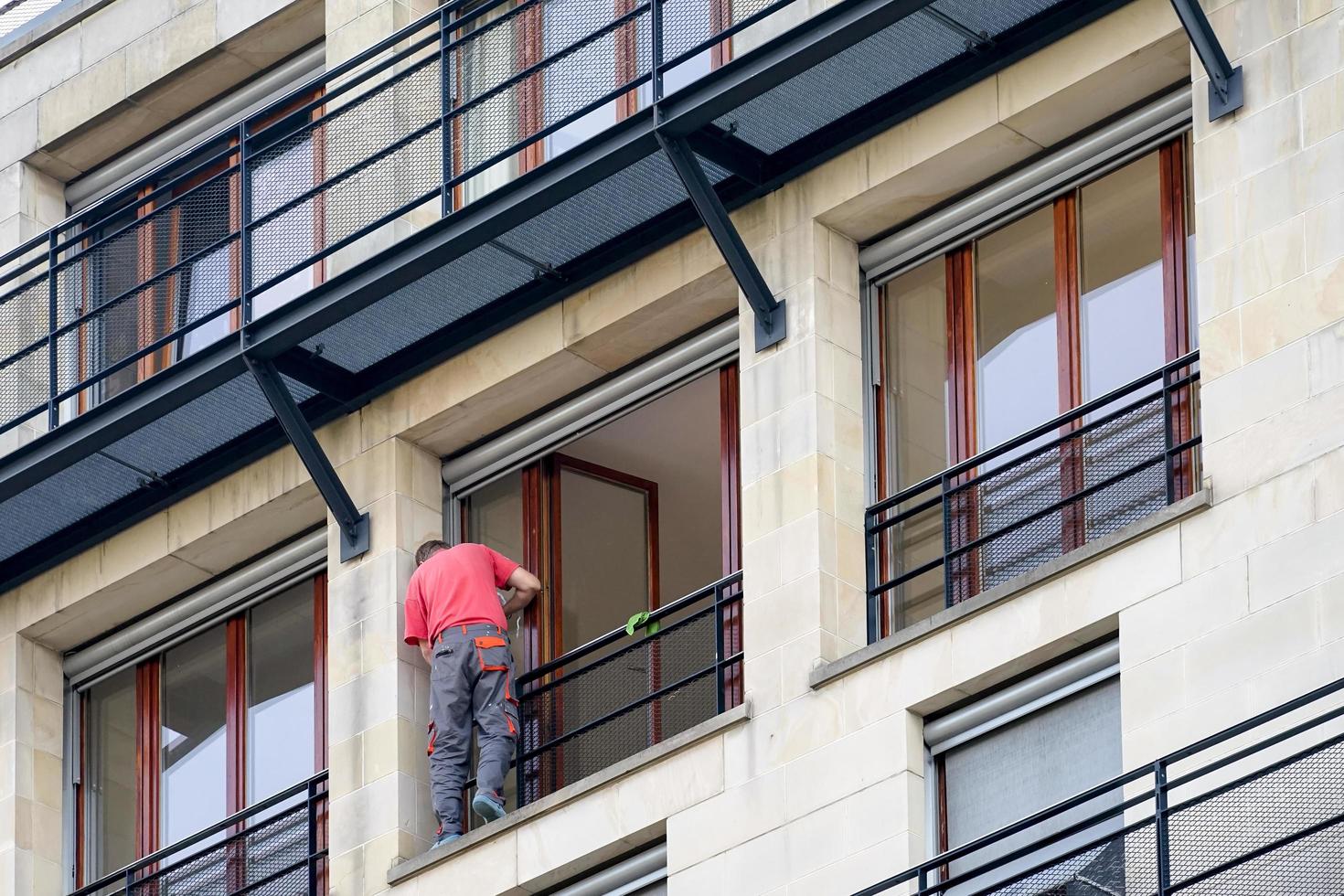 Berlin, Germany, 2014. Man carrying out repairs to a balcony in Berlin photo