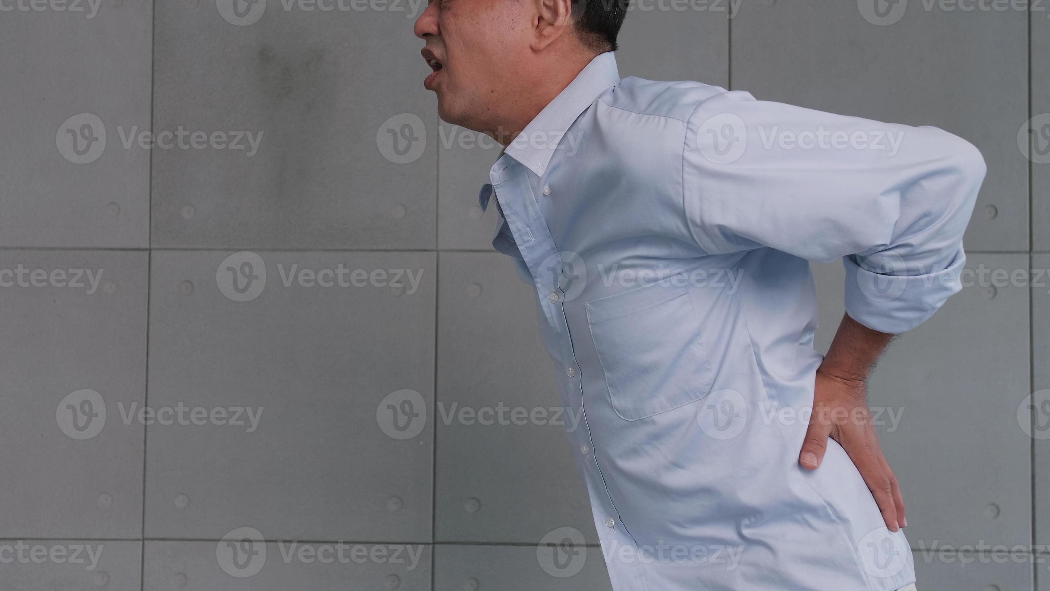Asian old man back pain after lifting heavy object. 11096946 Stock
