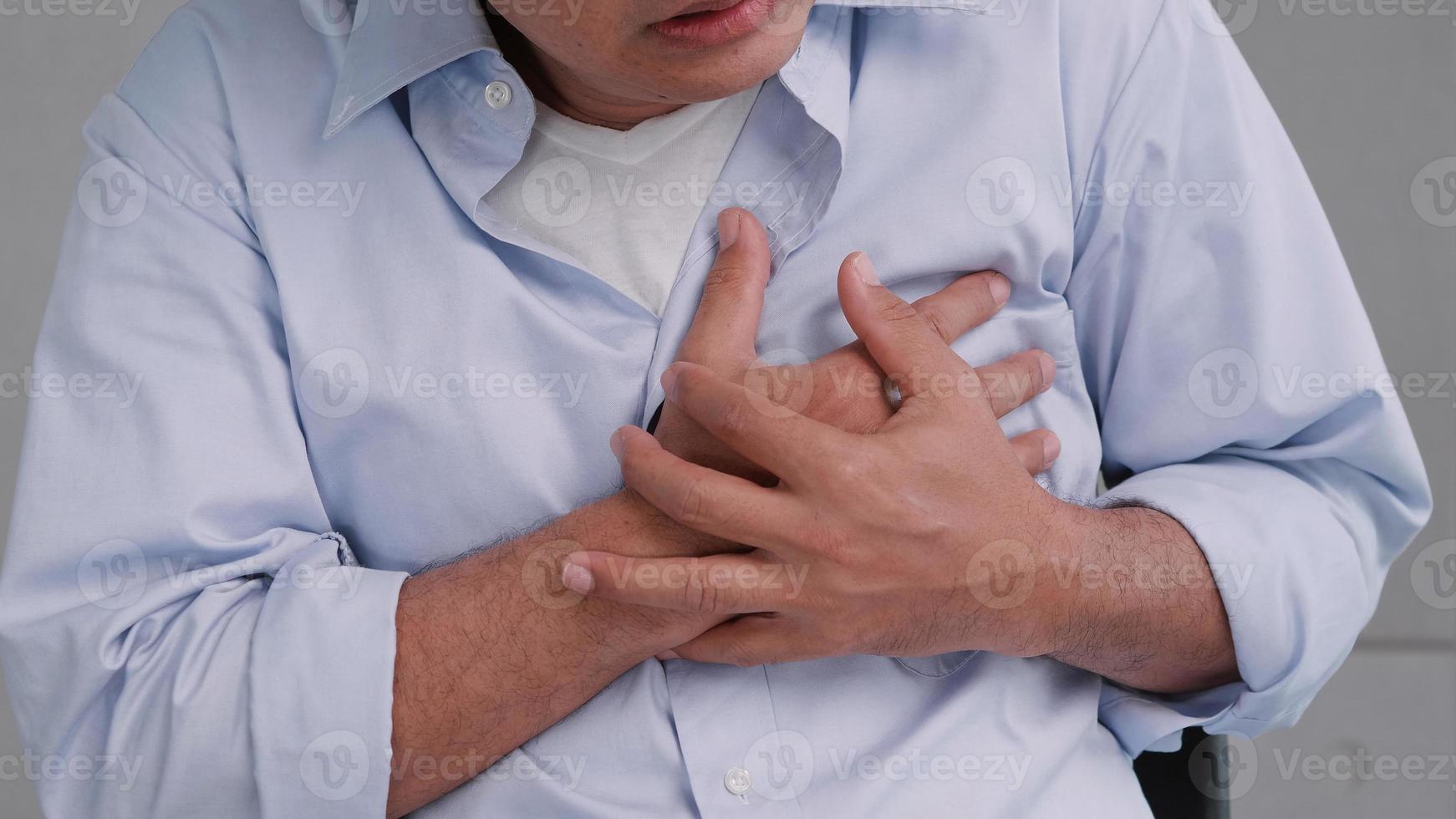 Asian man has chest pain caused by heart disease. photo