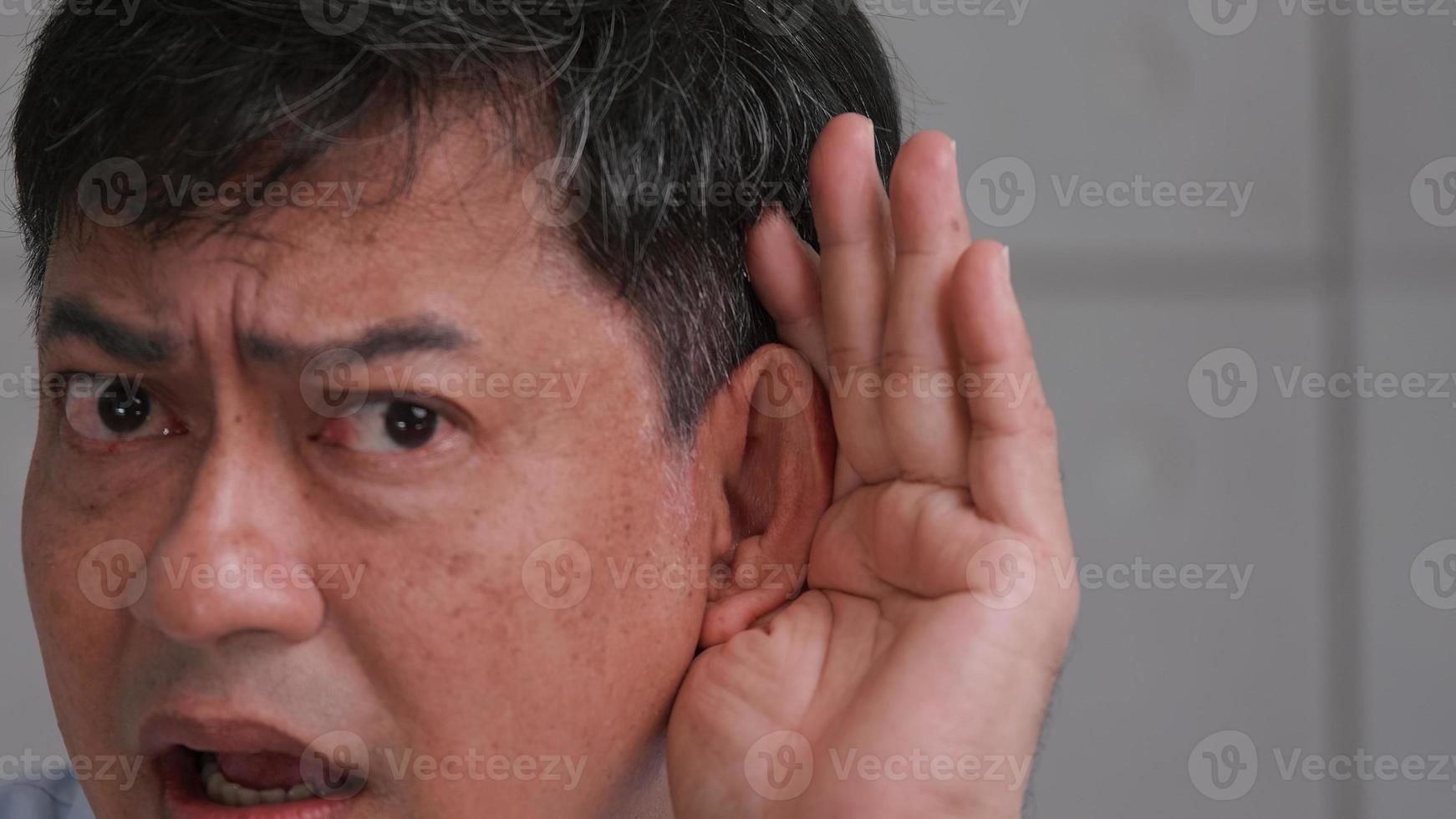Asian senior man couldn't hear the cause of his deafness. photo