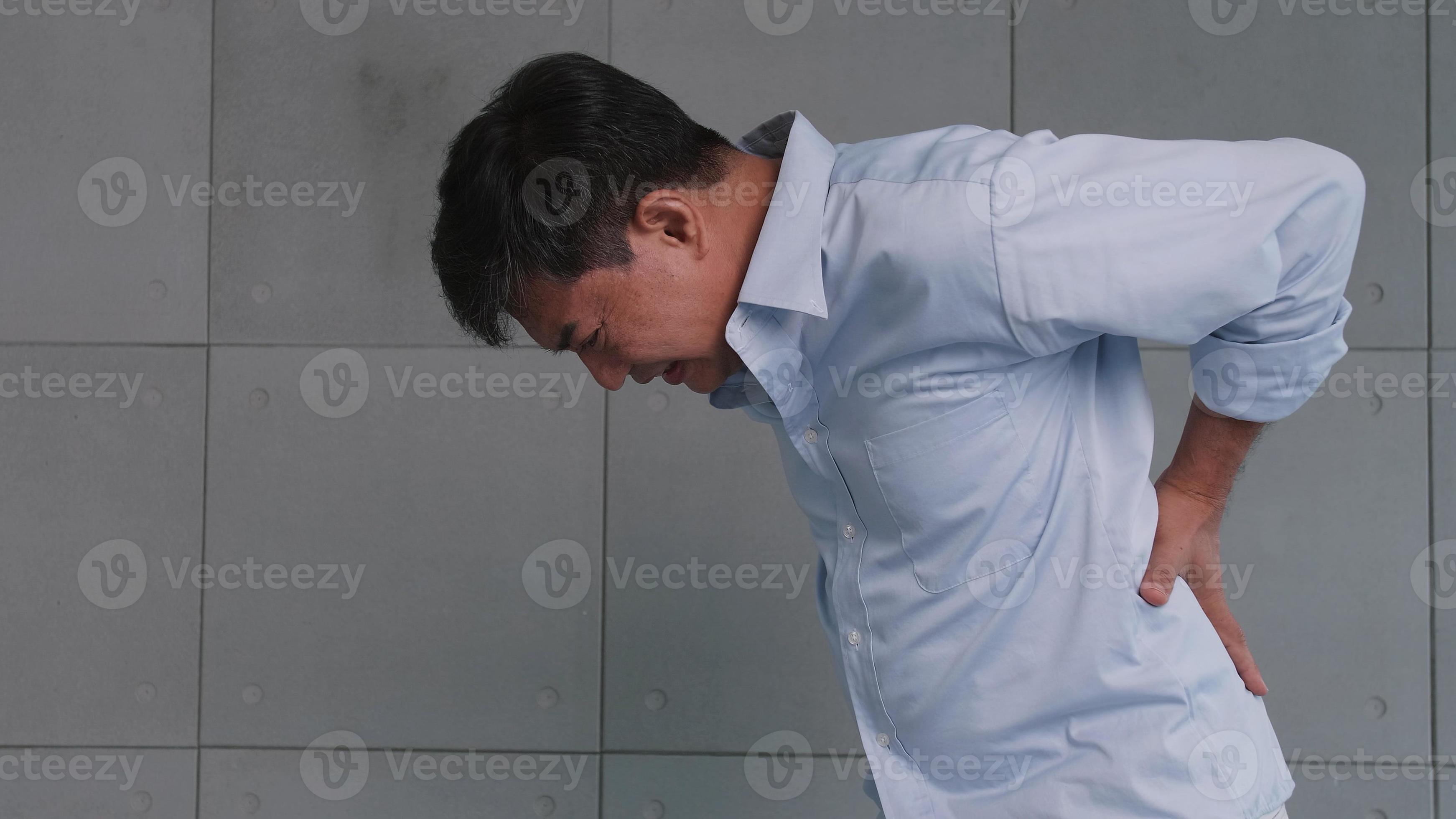 Asian old man back pain after lifting heavy object. 11098123 Stock