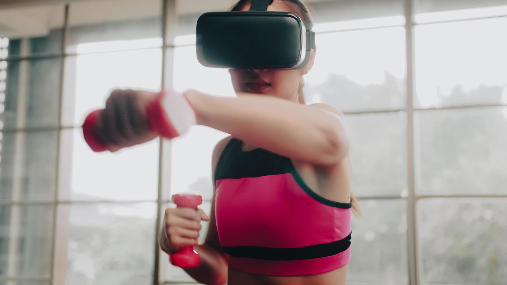 joven asiática con gafas de realidad virtual mientras hace ejercicio en casa. foto