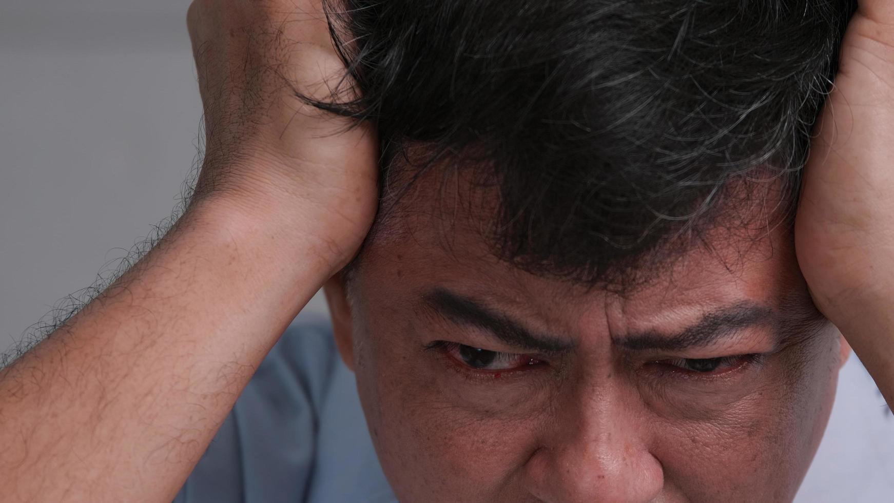 Asian old man with migraine headache. Man feel stressed and worried about health problems. photo