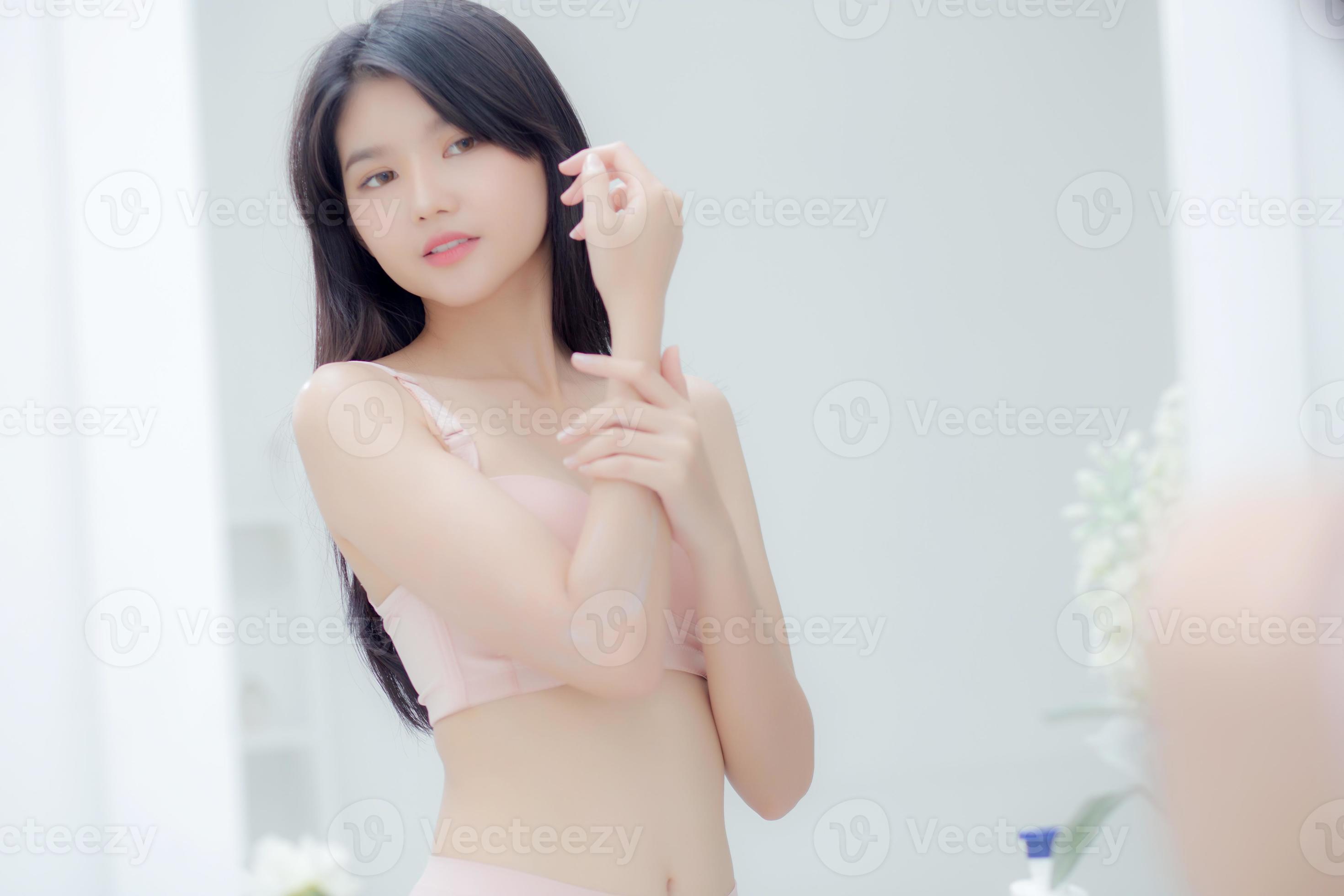 Beautiful sexy young asian woman looking mirror applying cream on arms and  message, beauty girl applying body lotion skin care for health and soft  hydration, treatment and cosmetic with moisturizer. 11098428 Stock