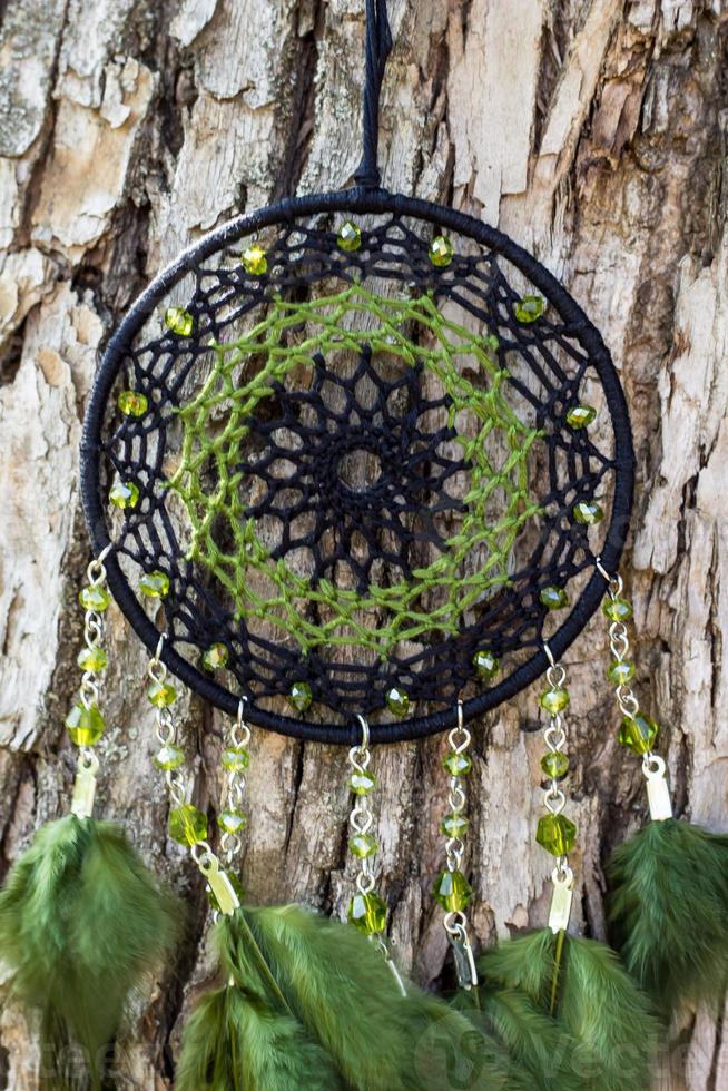 Handmade dream catcher with feathers threads and beads rope hanging photo