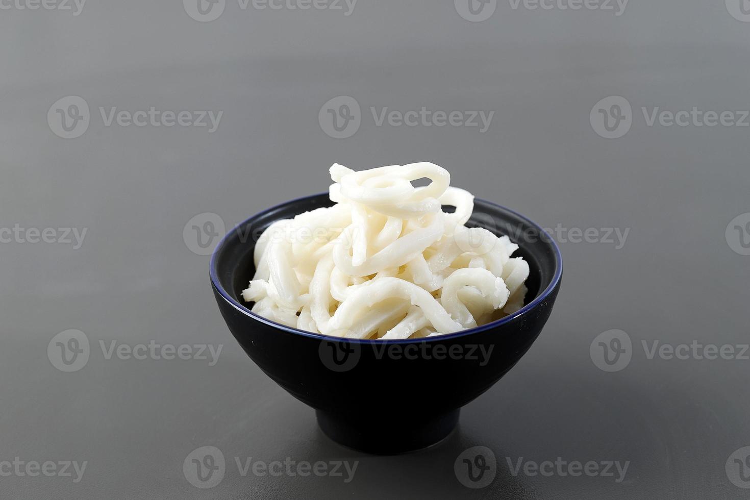 Japanese White Udon on Ceramic Bowl, isolated on Grey Table photo