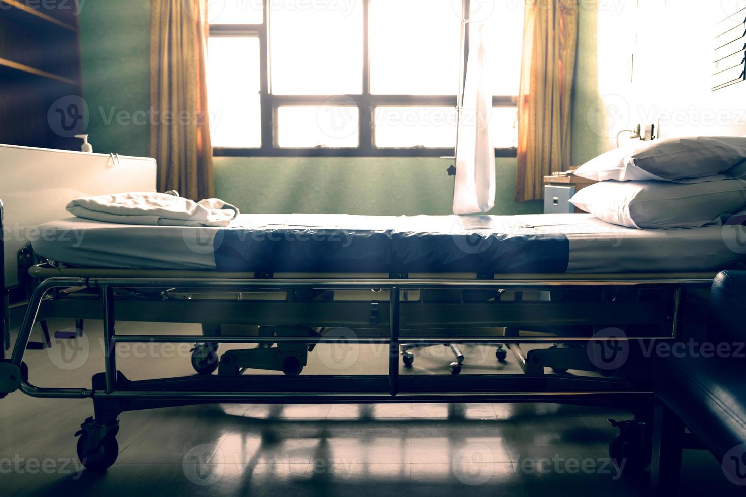 Empty  hospital bed with sunlight from the window,vintage tone photo