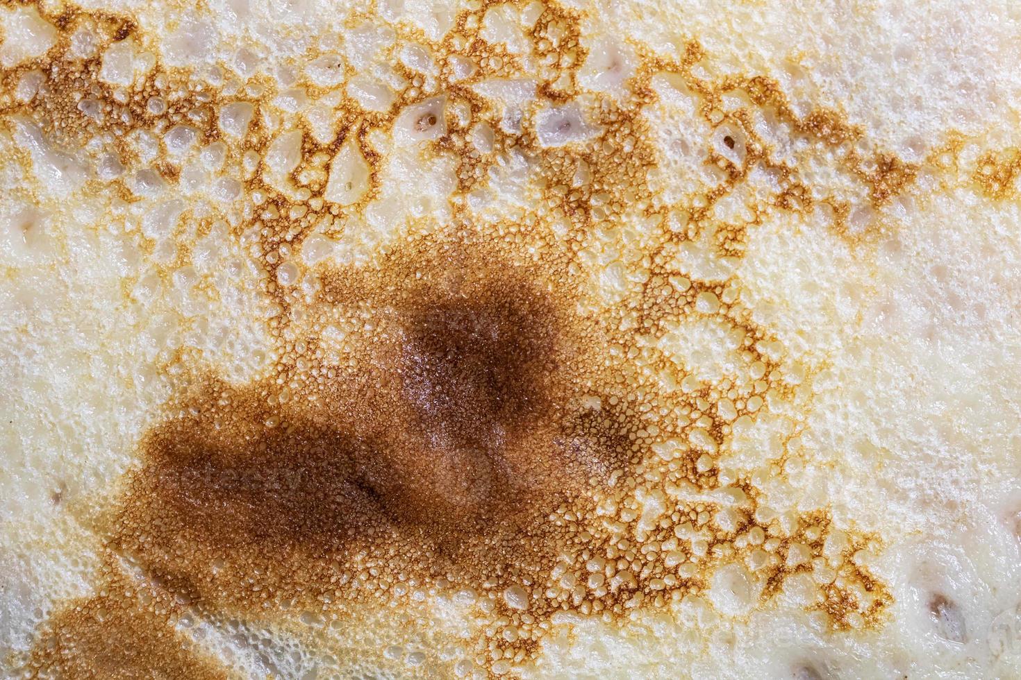 Pancake surface texture and pattern. Close-up of thin hot pancakes in a plate. Traditional rustic food. Graphic resource. photo