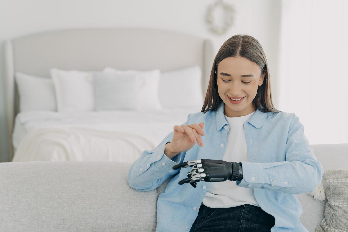 Happy girl is setting her electronic bionic limb. Engineering and innovation concept. photo