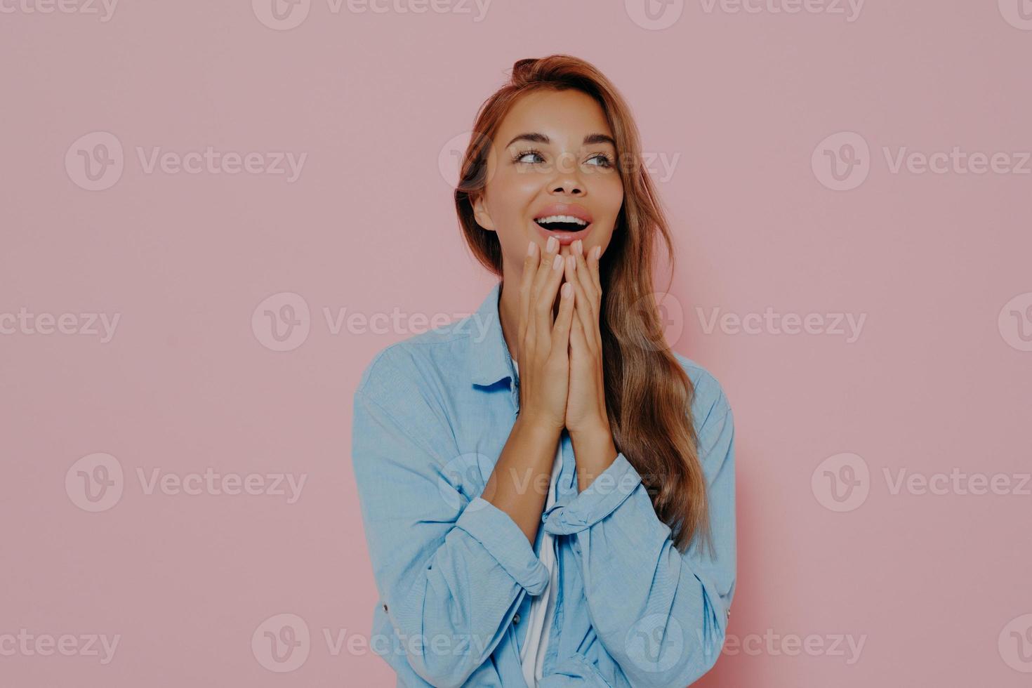 Close up shot of woman with delightfully surprised look photo