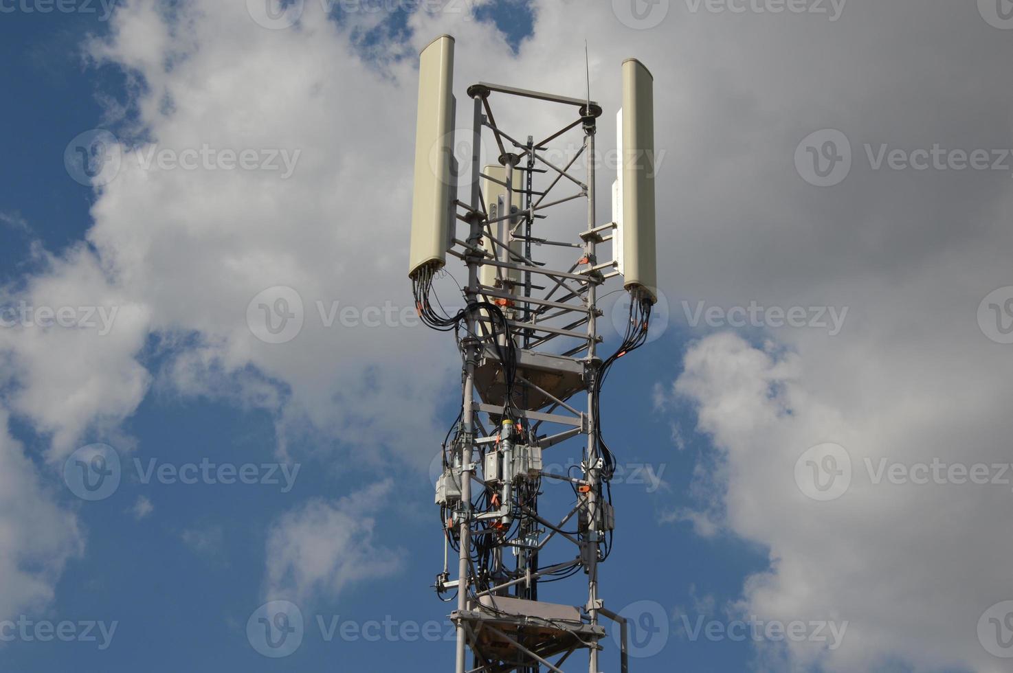 A Telecommunication antenna mast with a slightly cloudy background, France photo