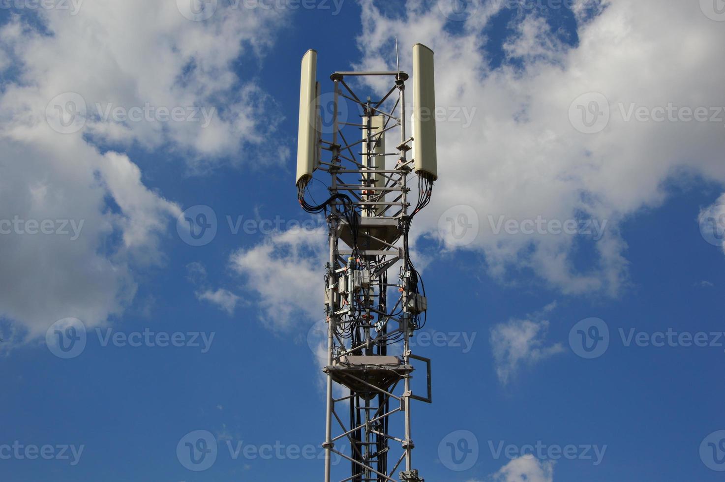 A Telecommunication antenna mast with a slightly cloudy background, France photo