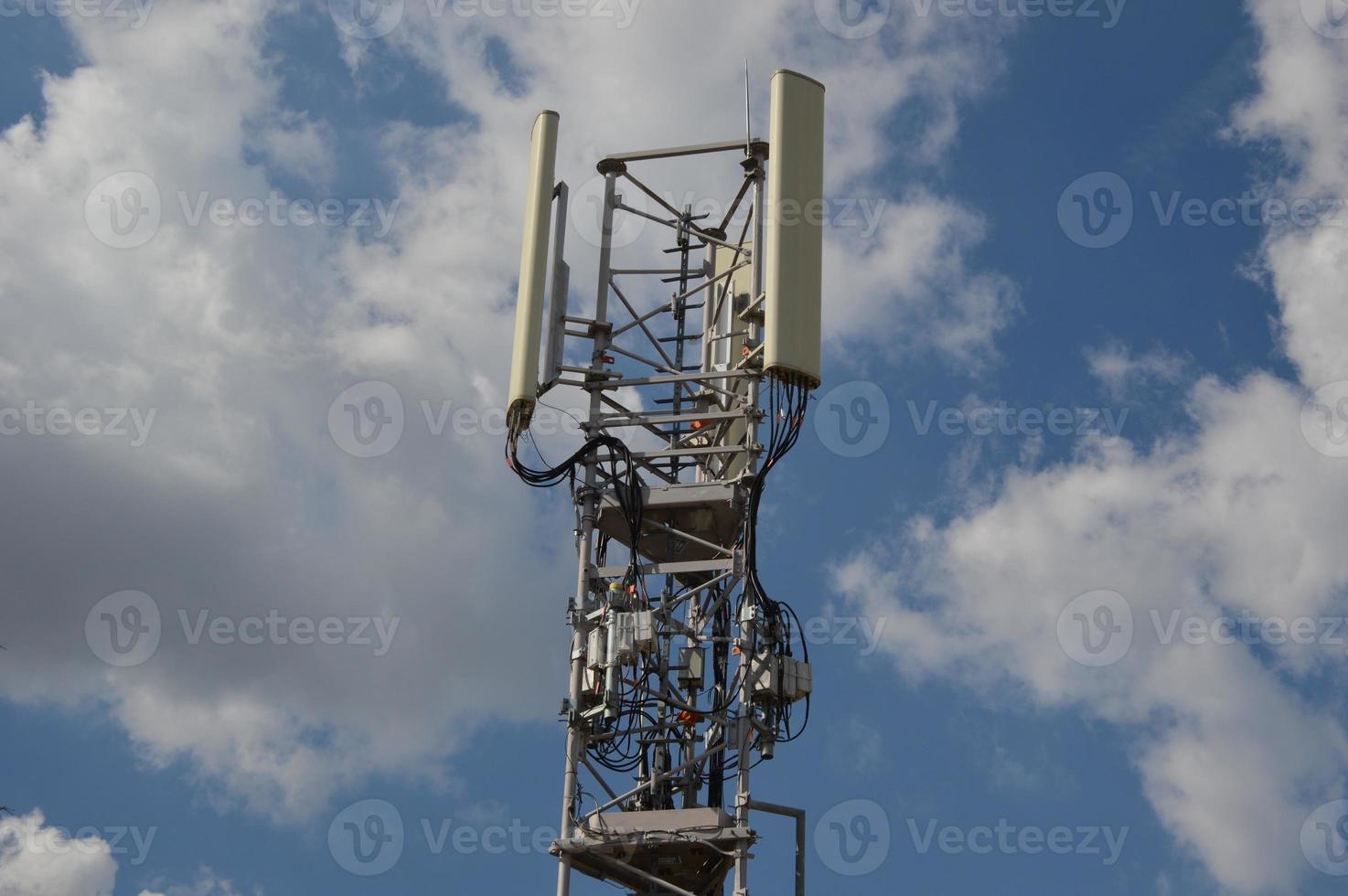 A Telecommunication antenna mast with a slightly cloudy background, France photo