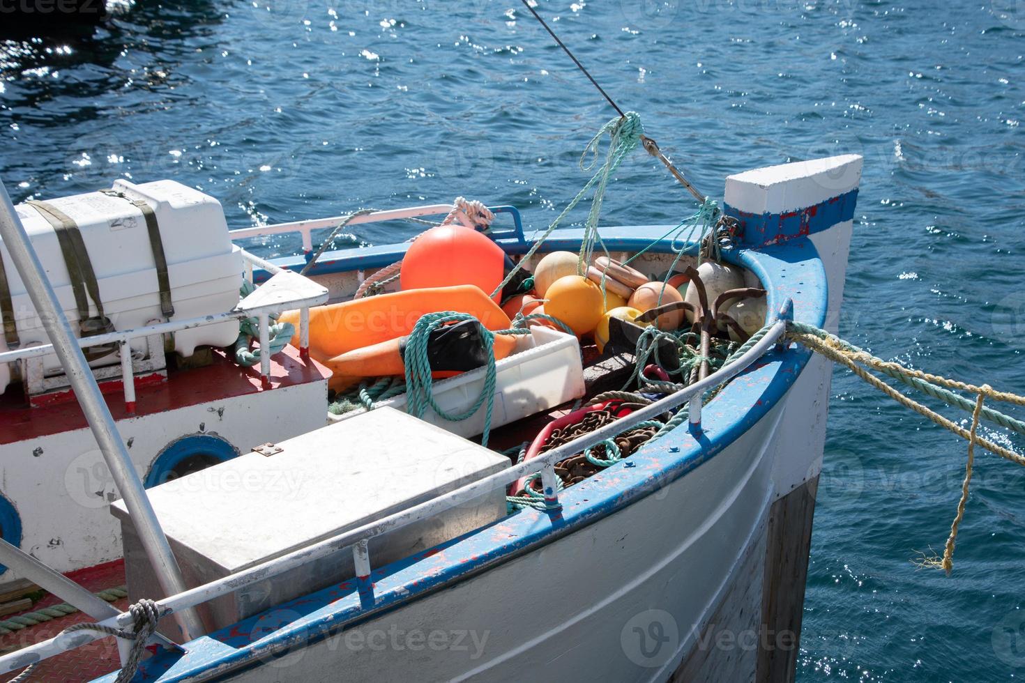 The bow of a white fishing boat in the harbor of Honningsvaag, Norway. photo