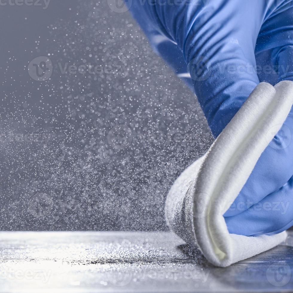 Spray disinfectant on a gray background. Surface treatment. The concept of disinfection. photo